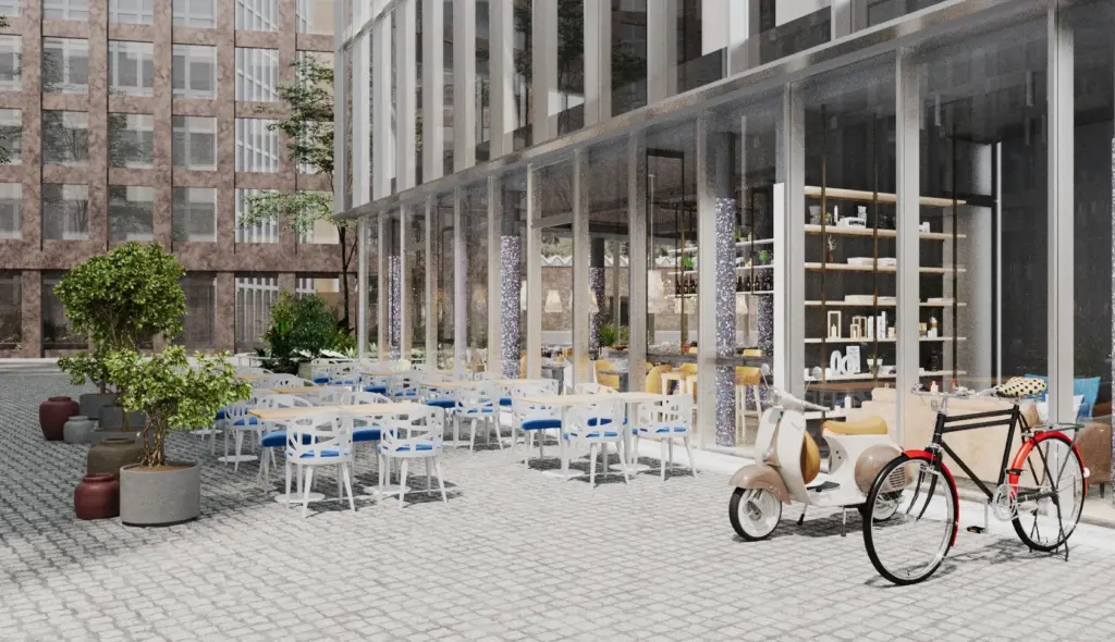 Gepflasterter Innenhof mit Bistrotischen, Velo und Fassade des Restaurants